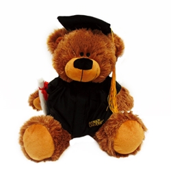 A twelve inch stuffed brown bear wearing a black robe and graduate cap holding a white diploma with a red ribbon. Gold Ryerson University text appears on the bottom right of the bear's robe.