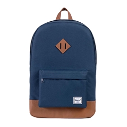 A blue Herschel backpack with brown leather details. Front pocket has the Herschel logo embroidered in white and black on the bottom right corner.
