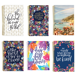 Six Bloom brand softcover, spiral ring planners. Planners come in a variety or marbled pastel colours, botanical prints and text-based inspirational quotes.